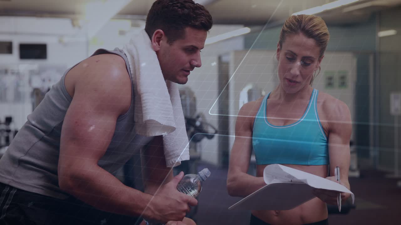 Female trainer pointing to clipboard, client leaning in, confirming fitness plan, overlay appearing