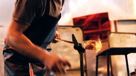 glassblower shaping a molten glass