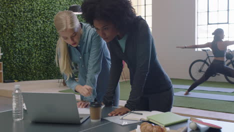 young business women brainstorming working together sharing ideas collaborating on project enjoying teamwork in modern office workplace