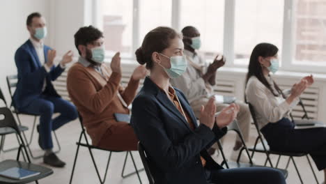 business people wearing masks applauding