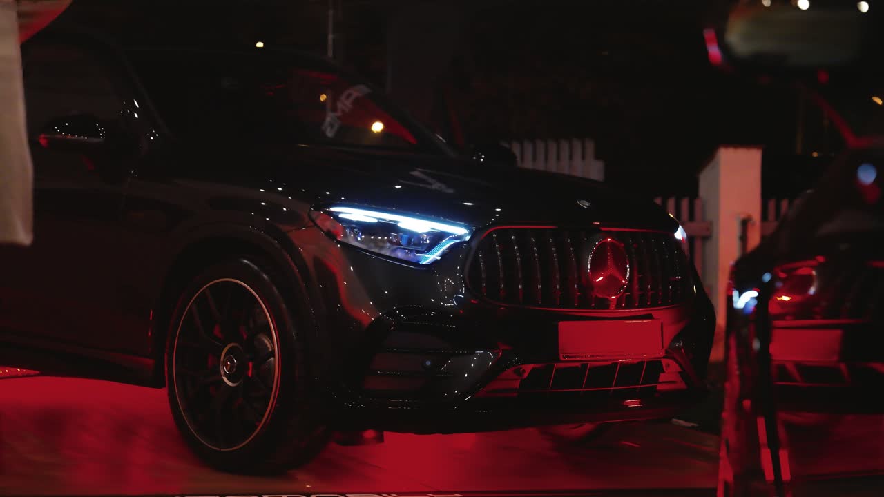 Black SUV car parked during motor show during late evening, Czechia