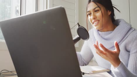 video of biracial woman taking part in online interview on laptop at home