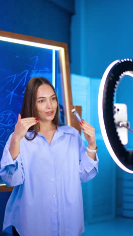 teacher clarifying ideas brightly. a teacher engages students using a ring light and markers, creating an inviting classroom atmosphere with blue decor