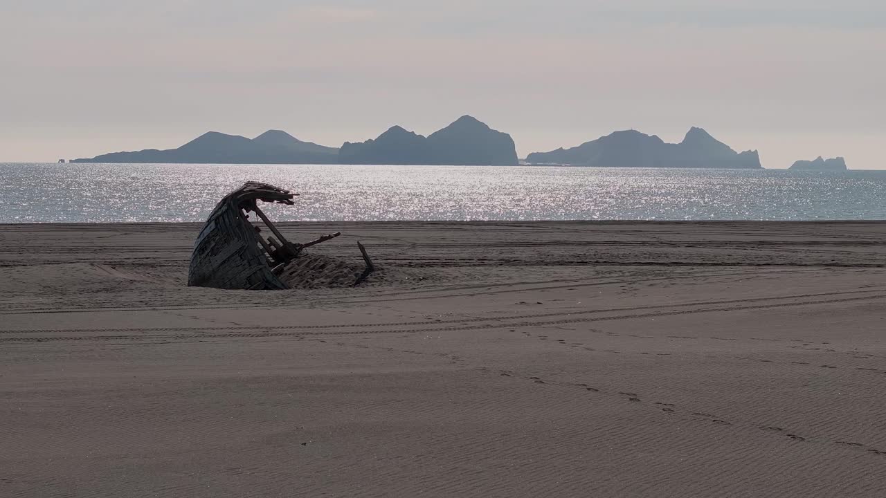 Desolated Wooden Ship On The Beach Near Vestmannaeyjar Archipelago In Iceland. Aerial Wide Shot