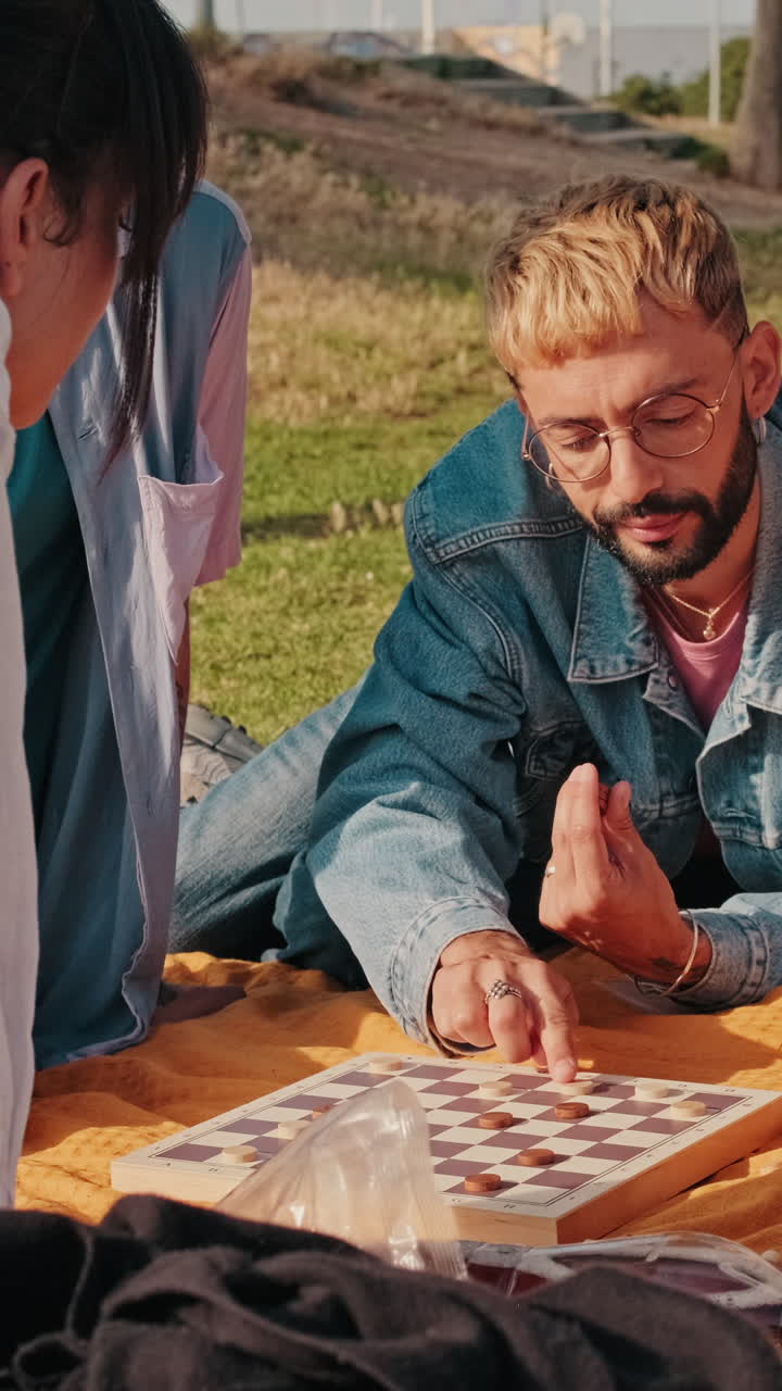 Friends Playing Checkers at a Picnic