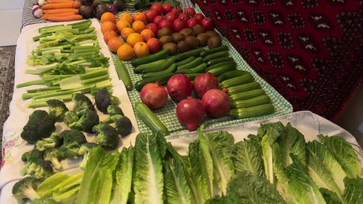 Fresh organic vegetables produce in grocery market washing cleaning preparation lettuce celery cucumber tomato carrot squash salad ingredient vegan vegetarian in kitchen homemade Persian family dining