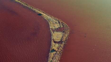 top panoramic coastline pink water reflecting golden sunlight. mineral island