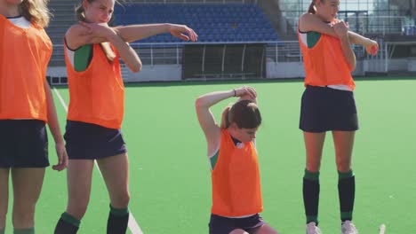 Female-hockey-players-exercising-on-the-field