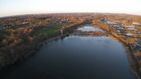 Lake-and-vast-landscape-of-Belgium,-aerial-drone-wide-lens-view