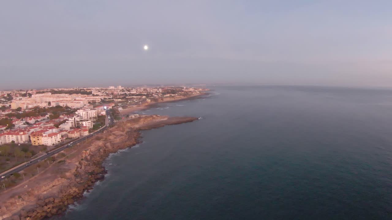 a moon view over the sea and the city.