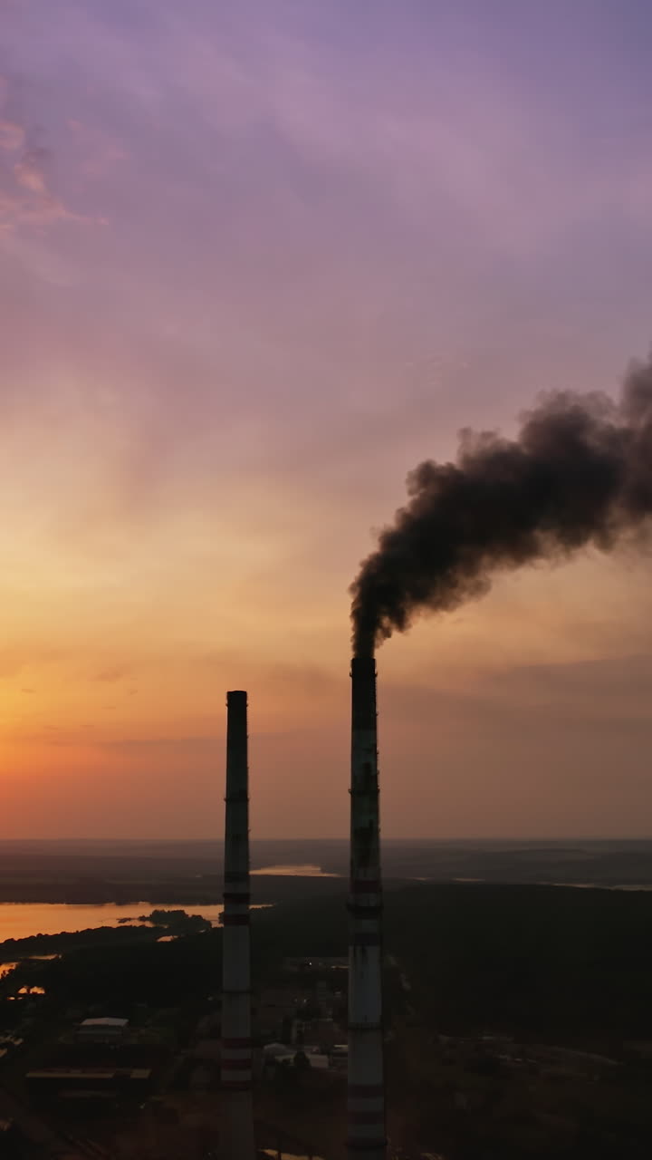 Air pollution smog from factory. Aerial drone view of factory during sunset