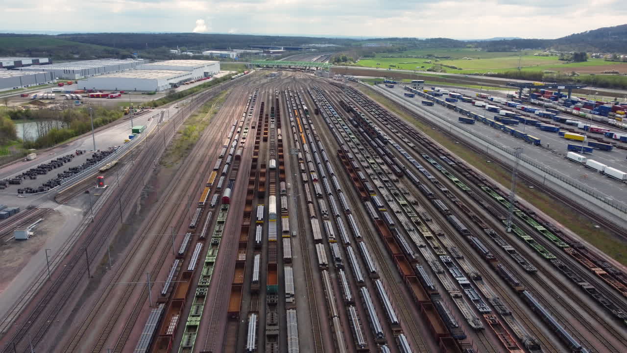 Aerial view of a busy railroad yard with freight cars