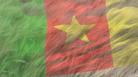 Digital-composition-of-waving-cameroon-flag-against-close-up-of-crops-in-farm-field