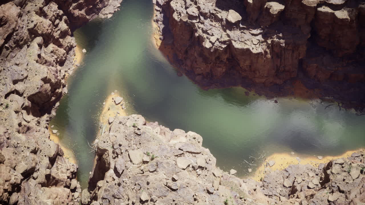 Exploring the winding river amidst rugged canyon landscapes in daylight