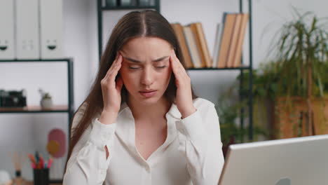 mujer de negocios caucásica cansada que sufre de dolor de cabeza problema de tensión migraña estrés en la oficina