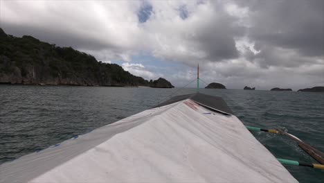 island hopping on an outrigger boat in the philippines