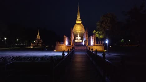 ukhothai historical park thailand buddha sculpture illuminated at night panoramic shot left to right