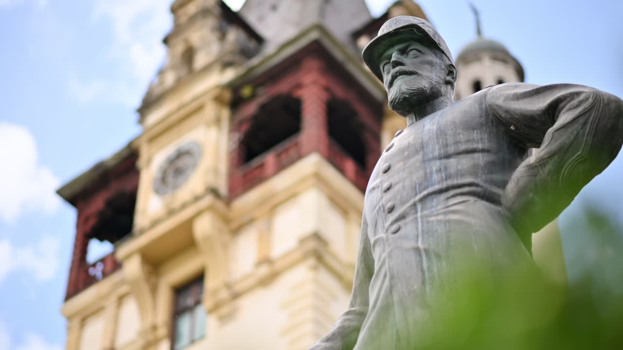Statua di Re Carol al Castello di Peleș in Romania. Castello sullo sfondo