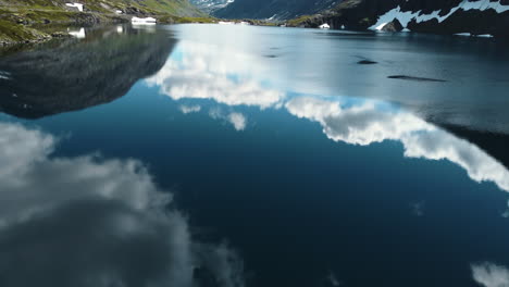 stunning reflections of clouds and mountains in a calm lake