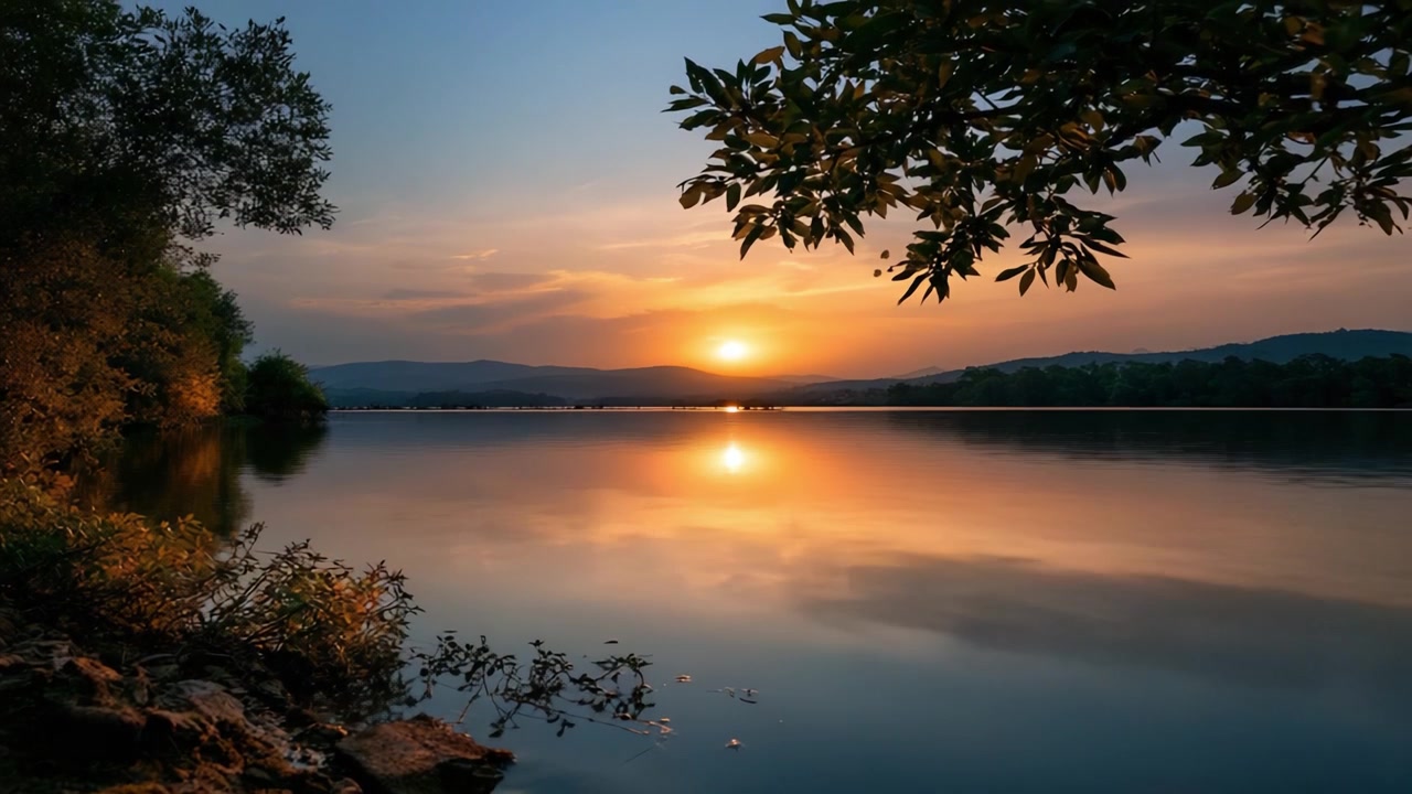 A Serene Sunset Over Tranquil Waters: Captivating Reflections and Vibrant Colors Illuminate a Peaceful Lakeside Scene as Day Transitions to Night