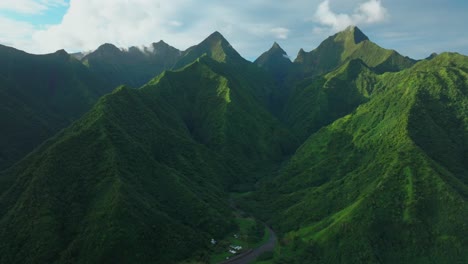 Late-afternoon-sunset-green-island-mountain-peaks-Teahupoo-Tahiti-French-Polynesia-aerial-drone-town-village-Paris-summer-Olympics-venue-Mount-Orohena-Aorai-Ronui-blue-sky-river-valley-circle-right