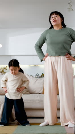 mother and daughter exercising at home