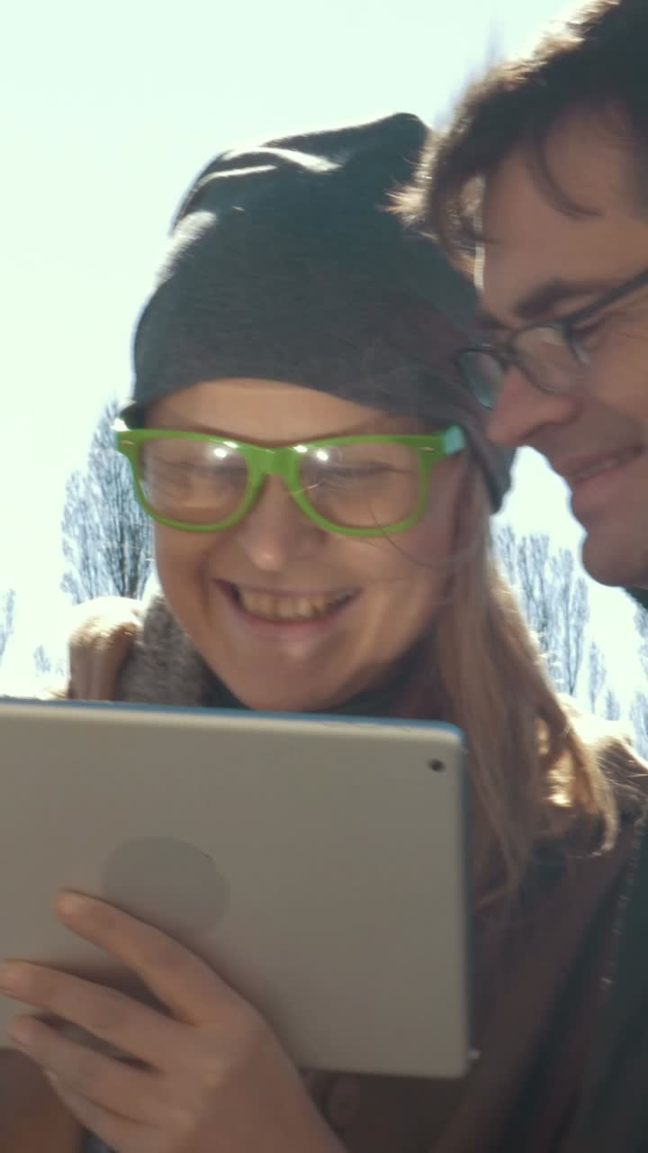 People using tablets outdoors