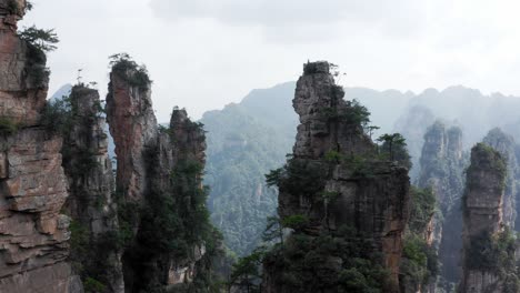 Aerial-trucking-pan-side-to-side-past-mountain-spires-in-zhangjiajie,-Wulingyuan-Hunan-China