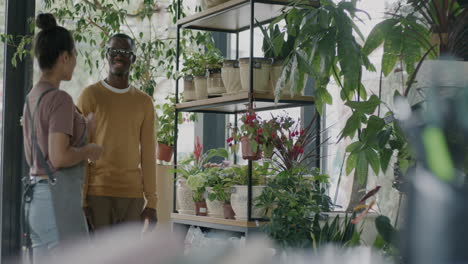 Customer interacting with plants in a shop