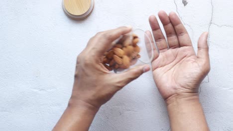 primer plano de nueces de almendra en la mano del hombre