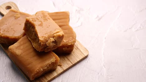 jaggery pieces on wooden cutting board