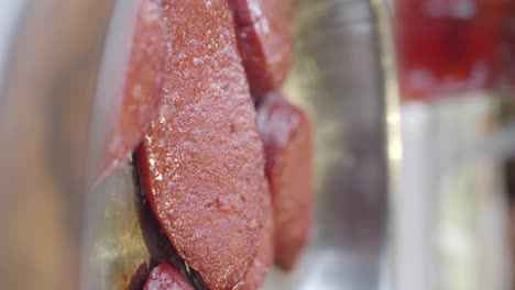 sliced sausages on a metal tray