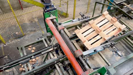 above view of a pallet tumbler machine rotating wood timber for industrial europallets automated manufacturing