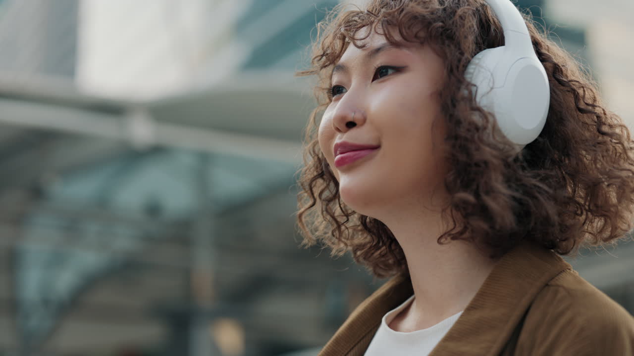 mujer escuchando música en la ciudad