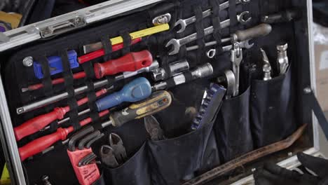 slow slide across mechanics tool box full of wrenches and tools at race track