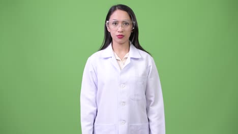 young beautiful asian woman doctor wearing protective glasses