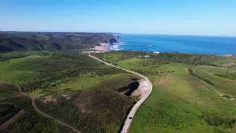road towards the shores of amado beach in carrapateira, algarve region of portugal. aerial drone shot
