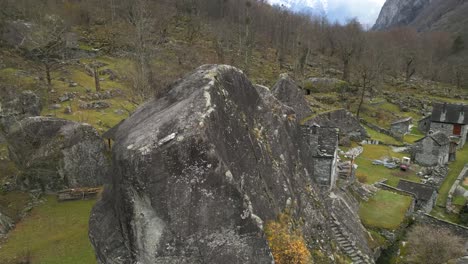 Drone-orbiting-around-the-village-of-Cavergno,-situated-in-Vallemaggia-district,-in-the-canton-of-Ticino,-Switzerland