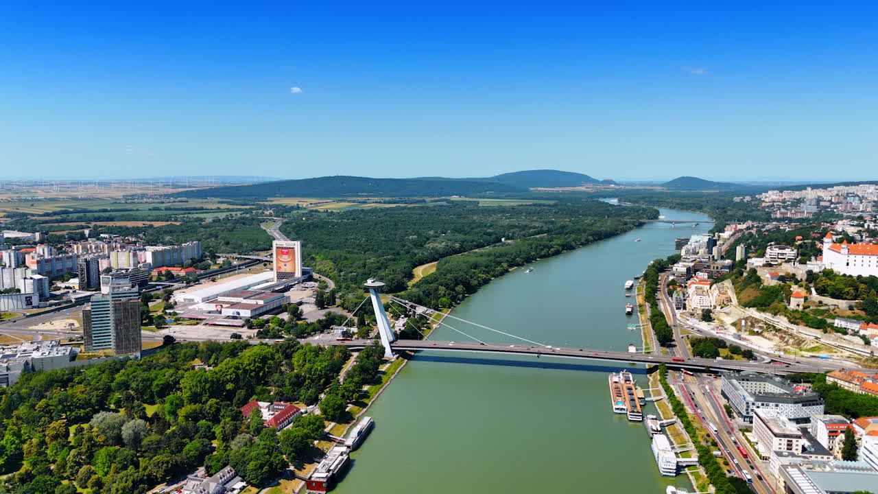 Stunning view of Bratislava from above. Aerial perspective showcasing the Danube River and urban landscape of Bratislava with green hills in the background