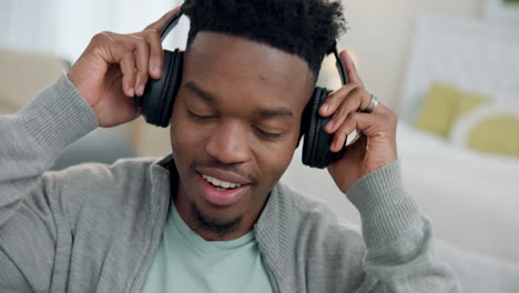 man, headphones and smile on sofa for sound