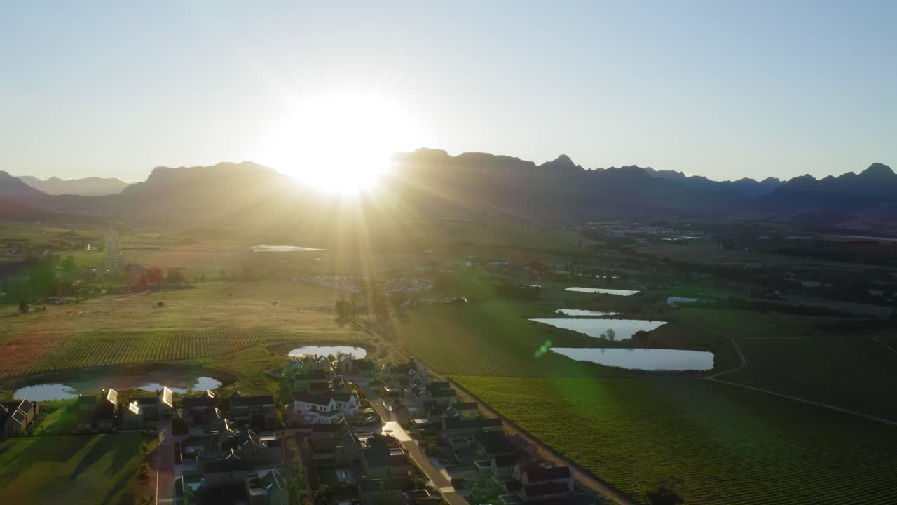 Houses on country estate at sunrise between vineyards and ponds mountains, stellenbosch, longlands