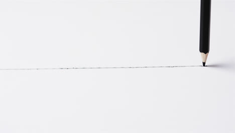 clouse up of pencil drawing line on white background with copy space, in slow motion