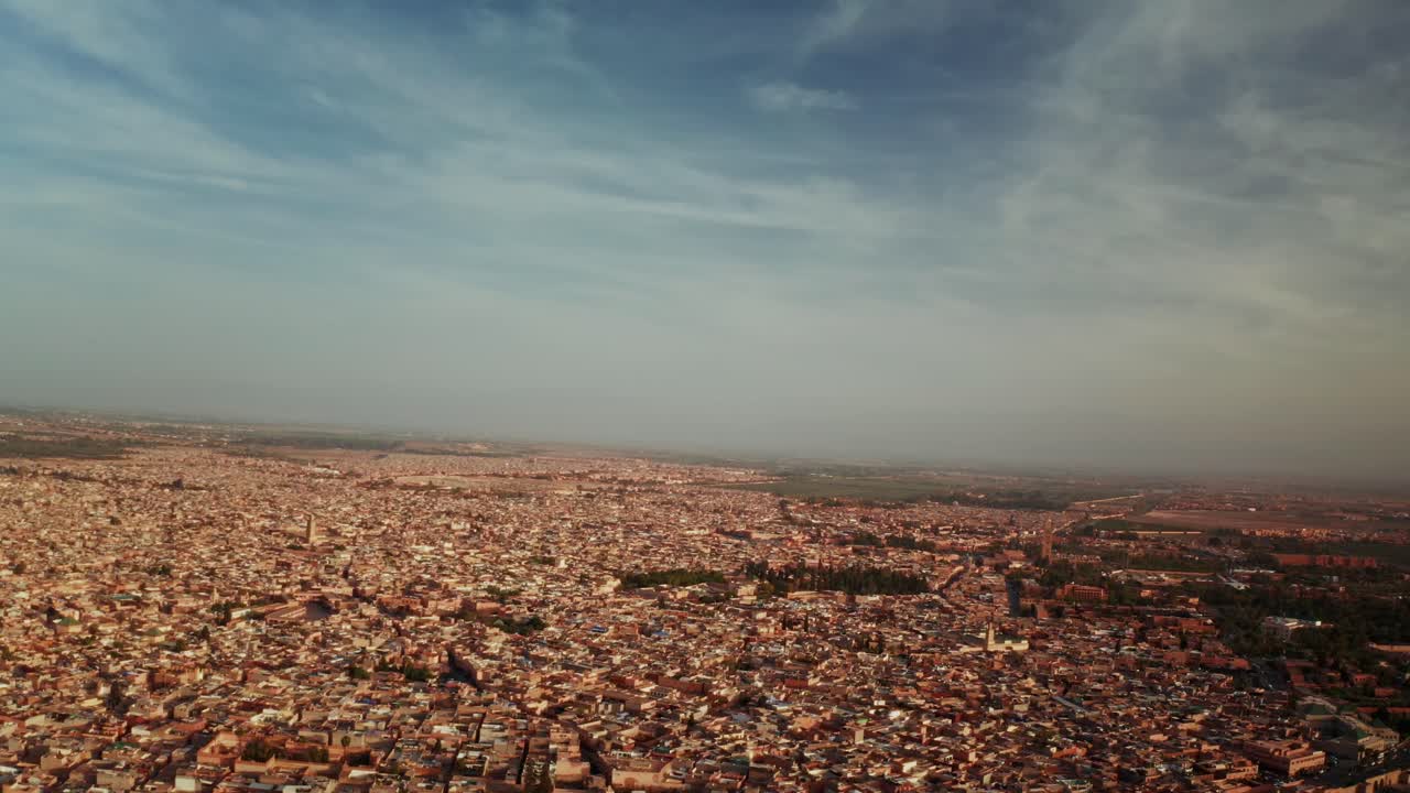 Aerial drone shot over the City of Marrakesh in Morocco. High view of the rooftops and narrow streets of Marrakesh.