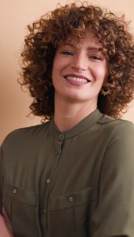 cheerful woman teasing and making face in studio. vertical orientation