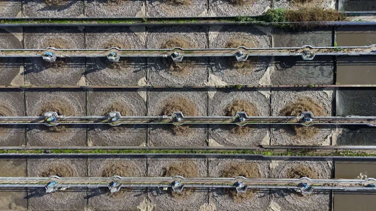 Drone flyover of sewage treatment station near Leicester, England, showing tanks, silos, and piping systems