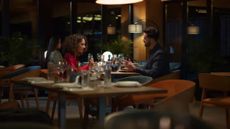 Mixed-race-couple-eating-enjoying-restaurant-food-meal-on-night-dinner-date.