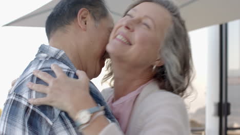 smiling senior couple embracing and enjoying vacation time outdoors together