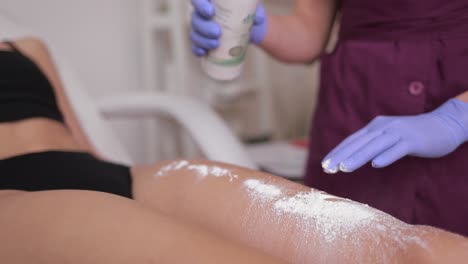 applying powder for hair removal treatment