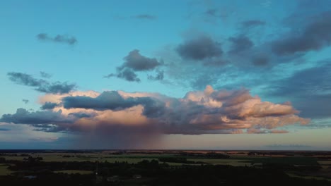 storm clouds with the rain. nature environment tornado warned supercell storm rolling through the plains. crop field after rain and storm clouds in background rural countryside. aerial dron shot