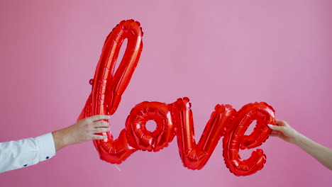 red balloons spelling love